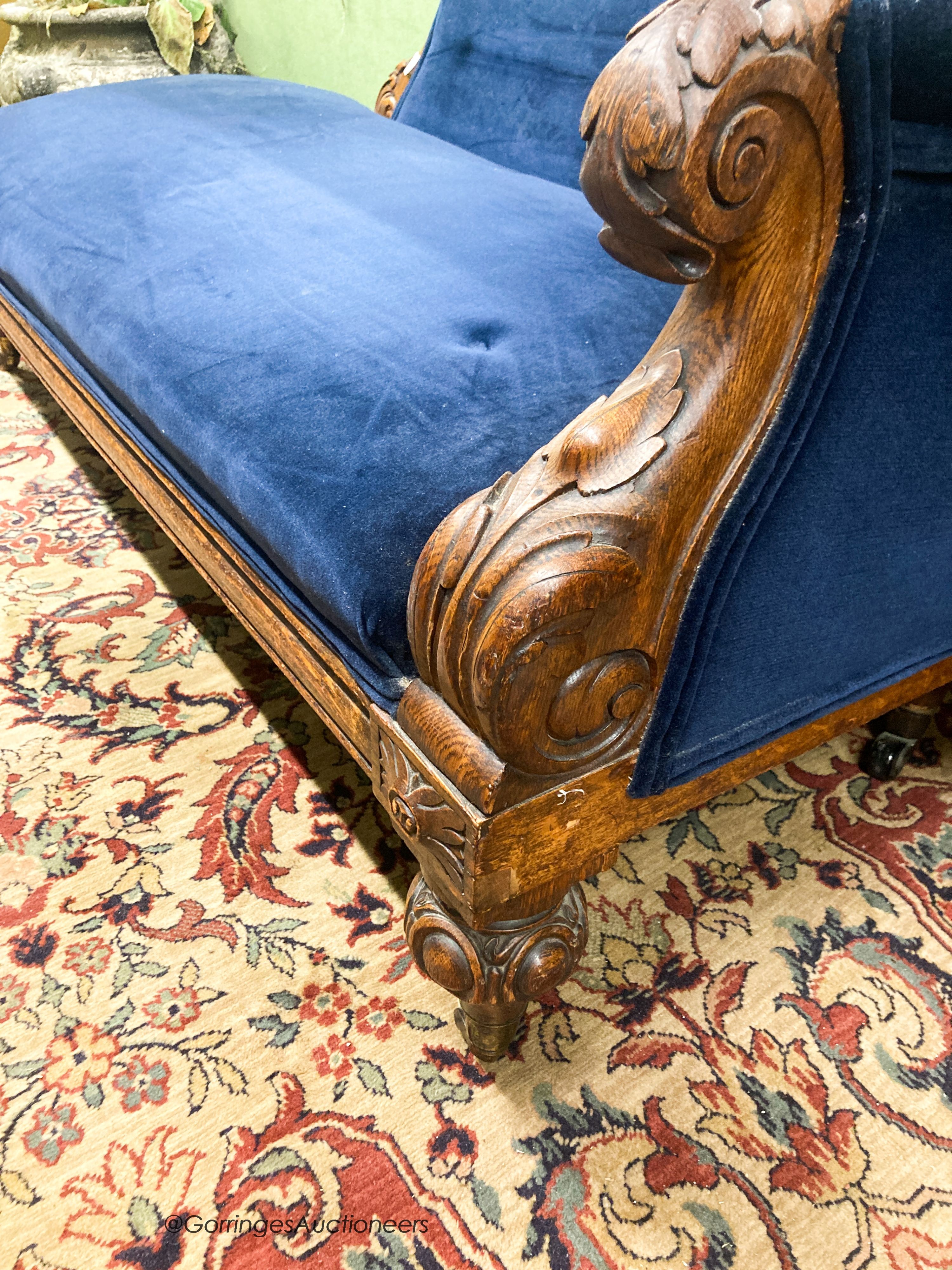 A Victorian carved oak chaise longue, W.180cm D.82cm H.84cm